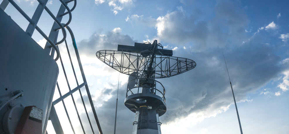 Communications tower with cloudy sky