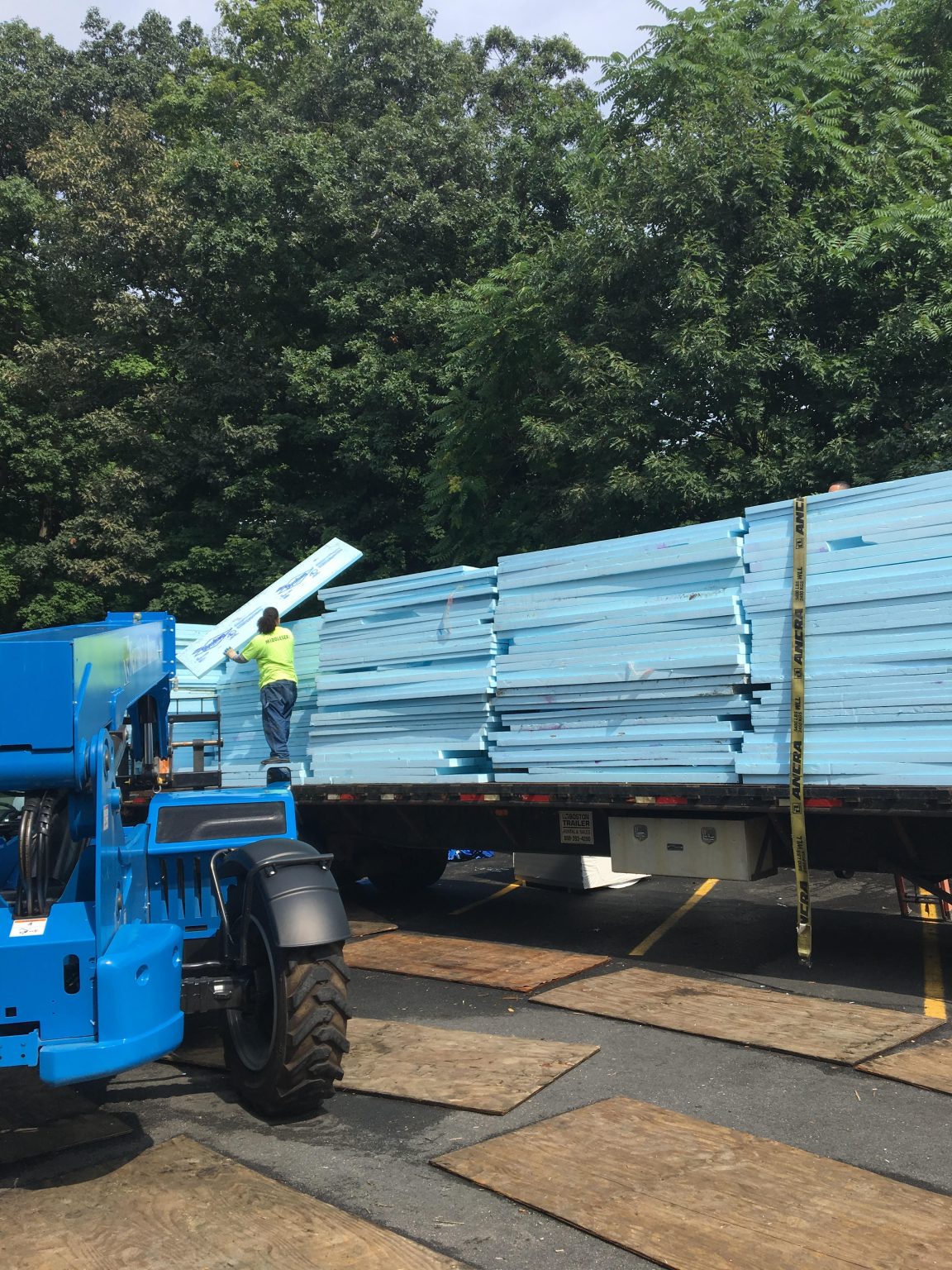 Blue rigid foam insulation being loaded for recycling