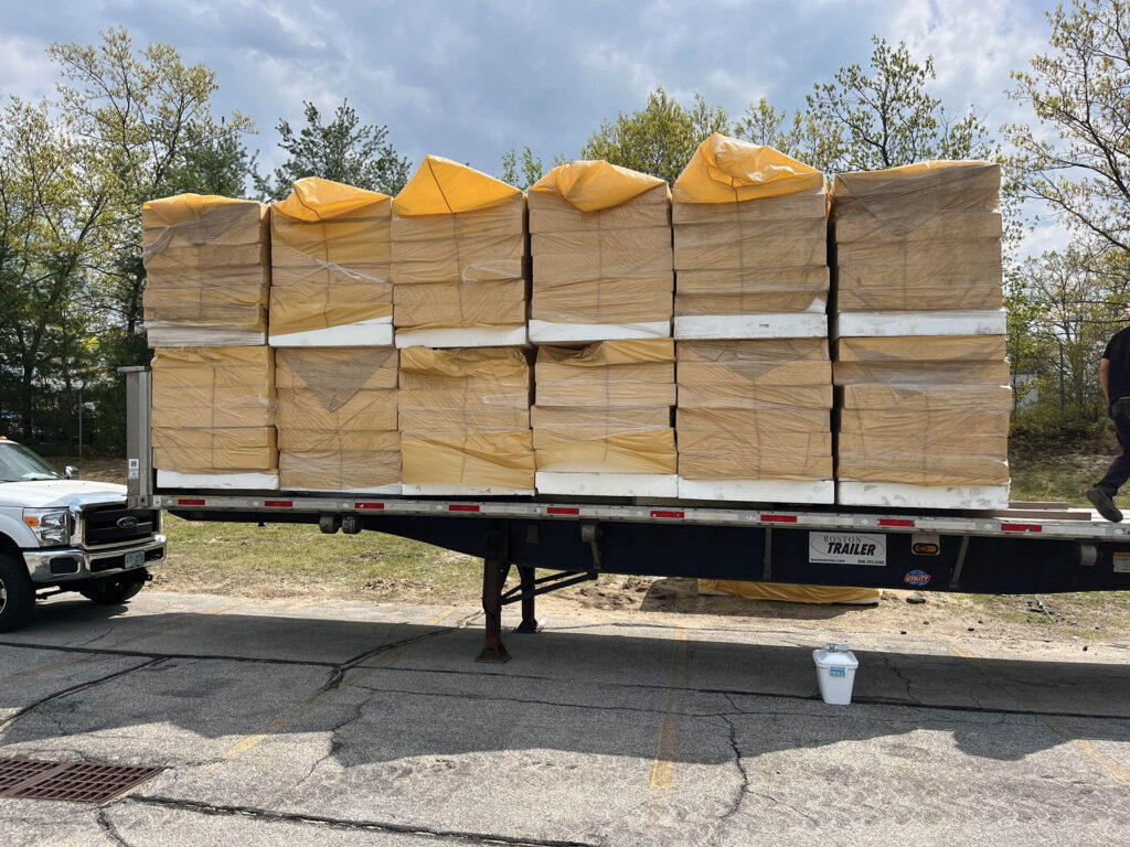 Wrapped roof insulation stacked on a trailer for recycling